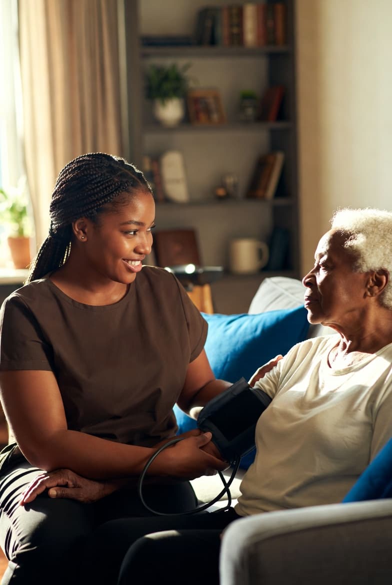 Personal care aide helping a senior with grooming and mobility assistance